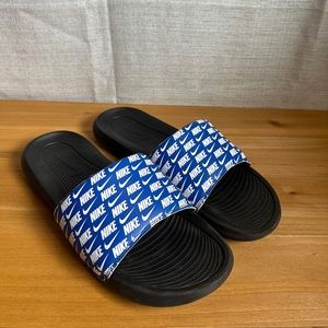 Blue and white Nike slides